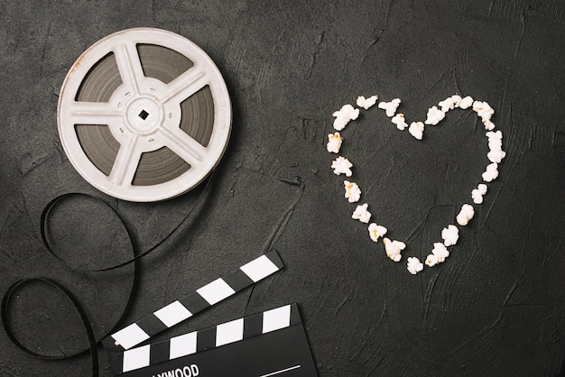 Free photo popcorn heart near film and clapperboard