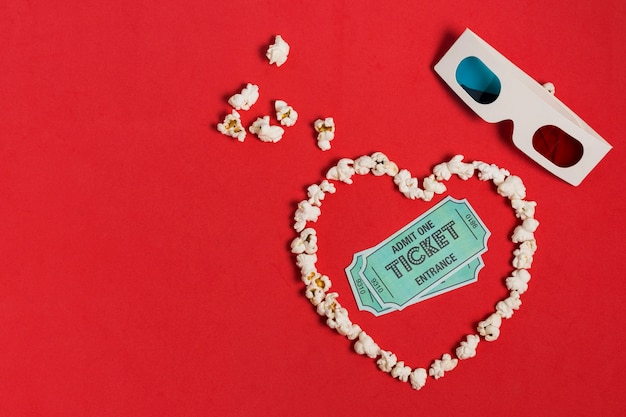 Popcorn heart shape with glasses and tickets