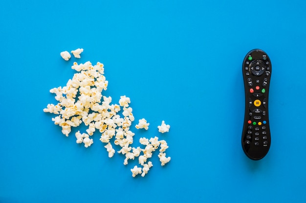 Popcorn next to remote control