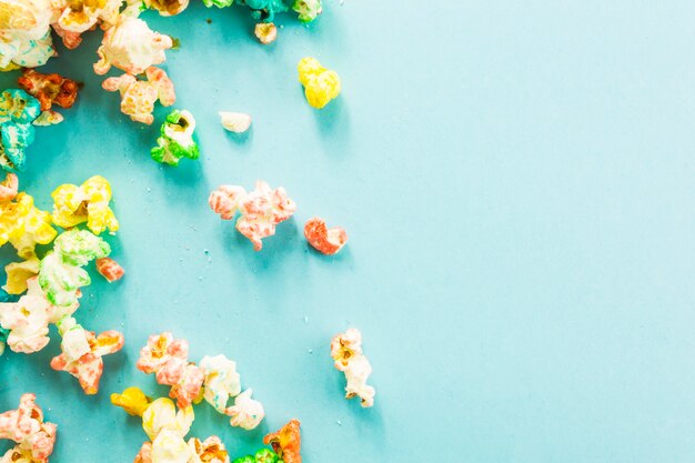 Popcorn spilled on blue background