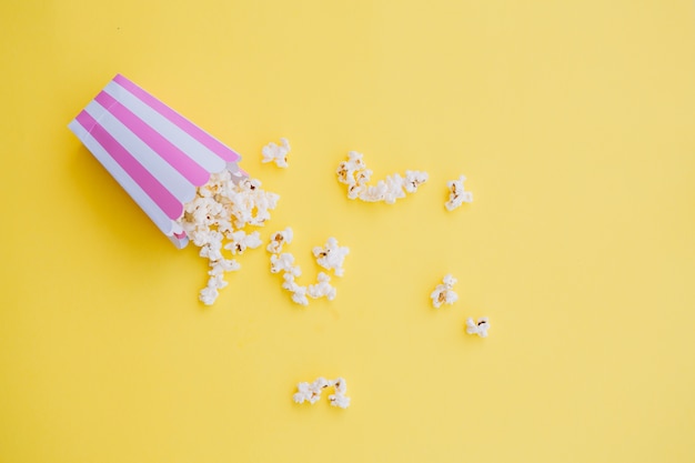 Popcorn spilled from striped box