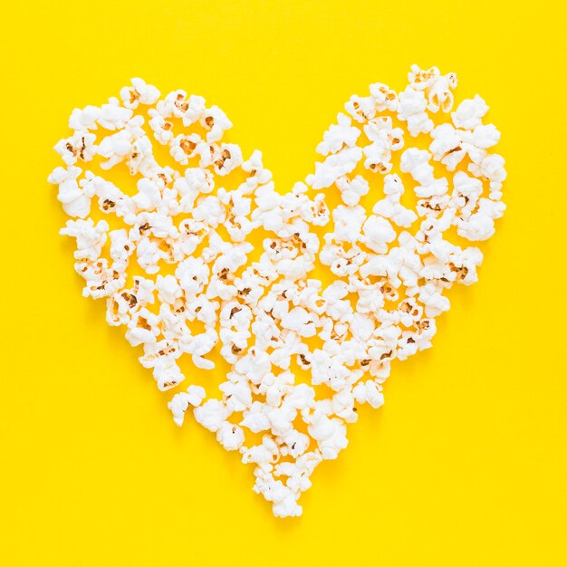 Popocorns heart on yellow background