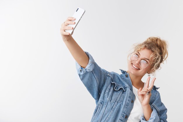 popular female blond internet blogger taking selfie