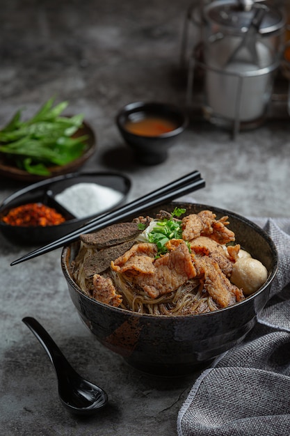 Pork boat noodles, classic Thai food and popular menus and ready to eat soups. There is also a basil in the bowl.