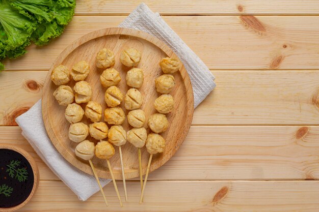 Pork meatballs on the wooden surface.