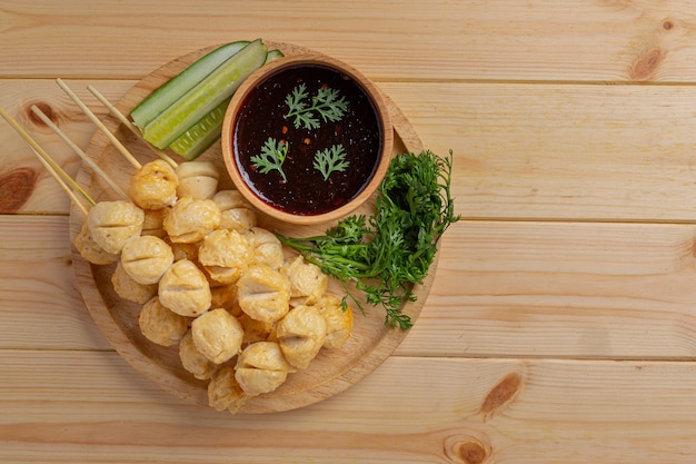 Pork meatballs on the wooden surface.