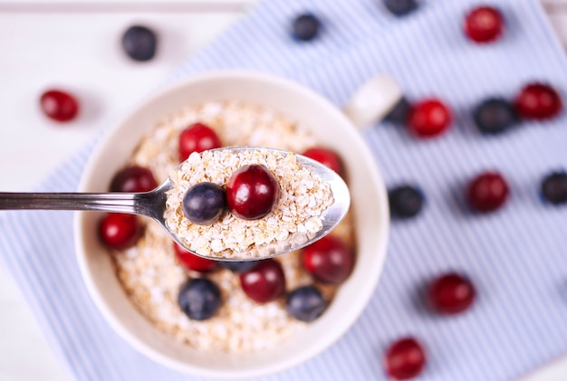 Porridge with fruit on spoon