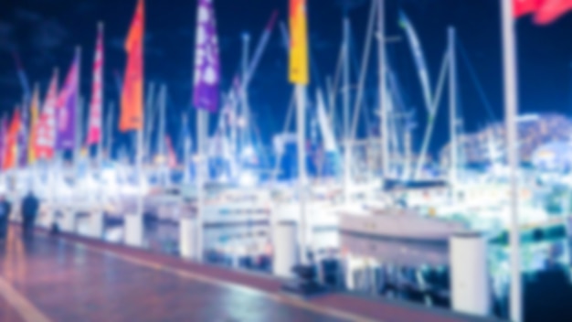 Port with boats out of focus with flags