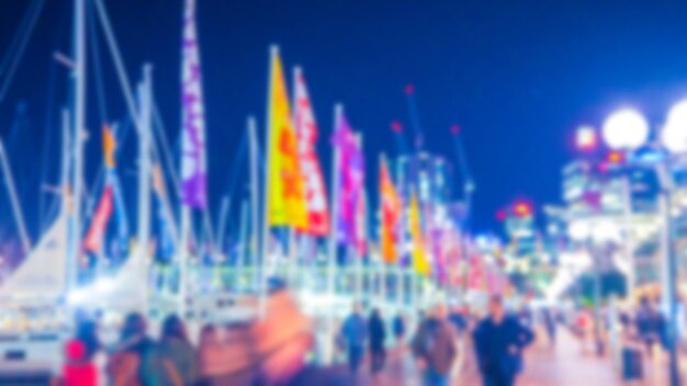 Port with boats out of focus with flags