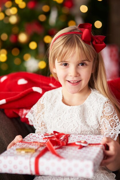 Portait of blond girl holding gift