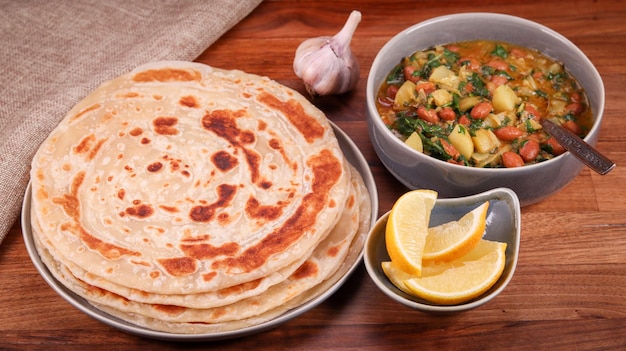 A portion of African chapati bean stew garlic and lemons