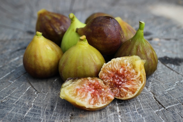 Free photo portion of fresh figs on vintage wooden background
