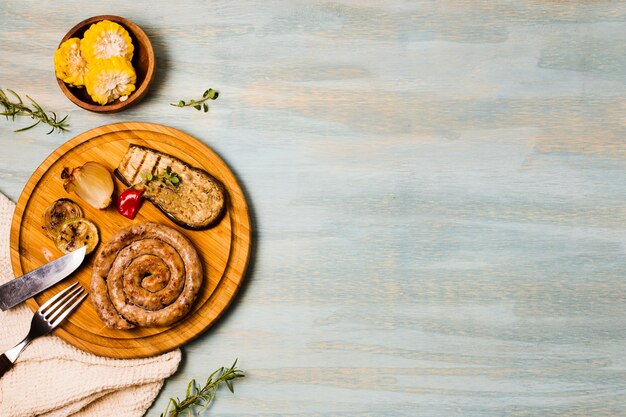 Portion of grilled sausages with garnish