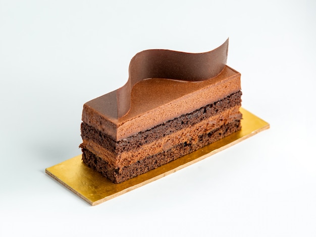Portioned chocolate cake garnished with thin chocolate wave