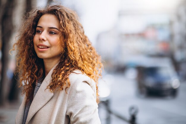 Portrair of a pretty woman with curly hair