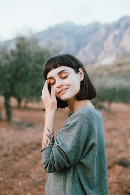 Portrait of adorable and attractive cute petite woman or young traveling female smiling