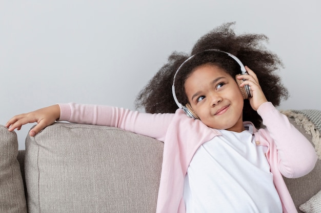 Portrait of adorable little girl listening to music