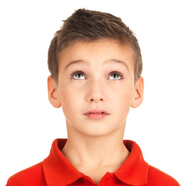 Portrait of adorable young boy looking up. Isolated on white