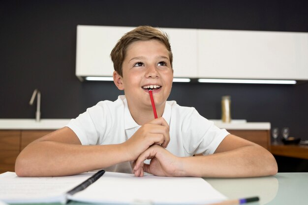 Portrait of adorable young boy thinking