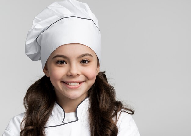 Portrait of adorable young chef smiling