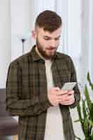 Free photo portrait of adult male browsing mobile phone