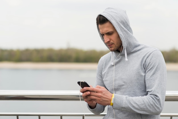 Free photo portrait of adult male checking his mobile phone