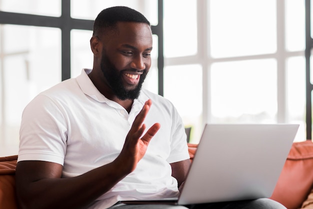 Portrait of adult male doing video call with friend