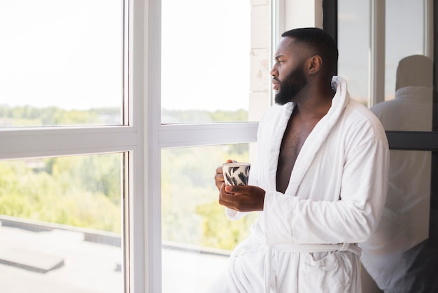 Portrait of adult male enjoying cup of coffee