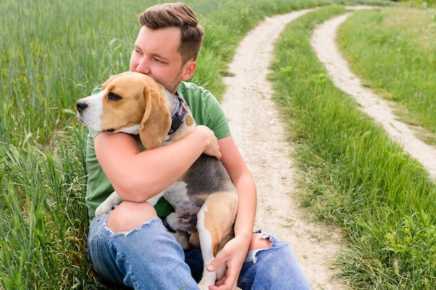 Portrait of adult male holding cute beagle