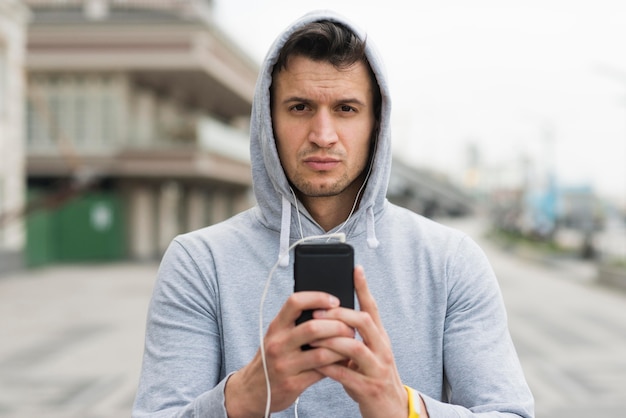 Portrait of adult male holding his mobile phone