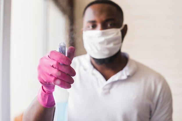 Portrait of adult male holding spray bottle