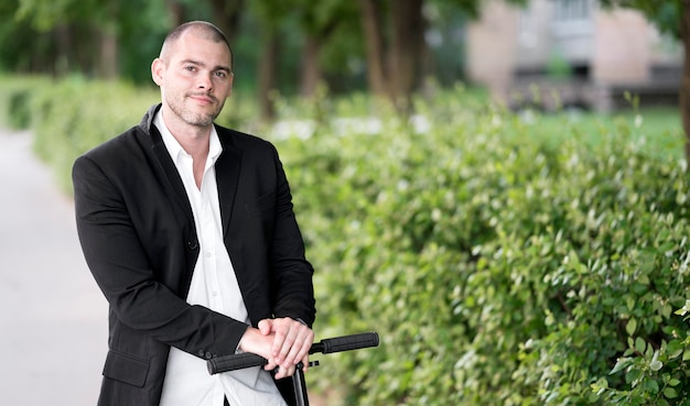 Portrait of adult male riding scooter outdoor