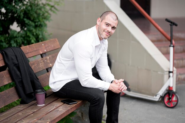 Portrait of adult male sitting on a bench