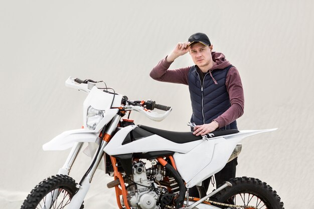 Portrait of adult male trying to repair motorcycle