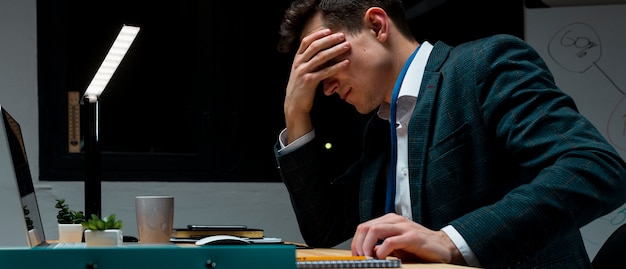 Free photo portrait of adult male working from home at night