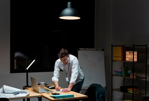 Free photo portrait of adult male working from home at night