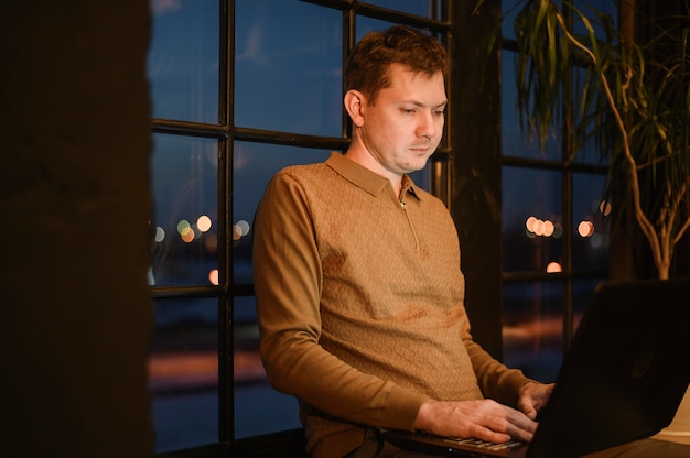 Portrait of adult male working on laptop