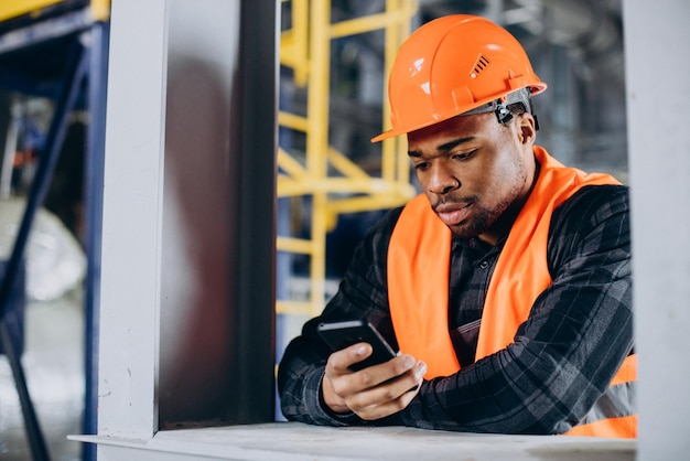 Portrait of african american man talking on the phone at a factory