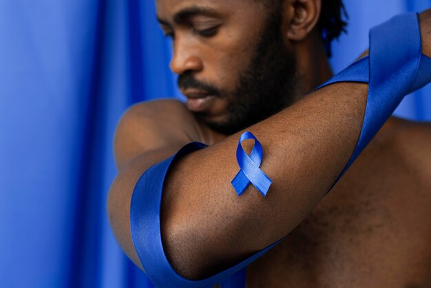 Portrait of african american man with blue ribbon