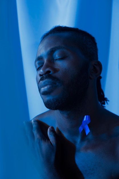 Portrait of african american man with blue ribbon