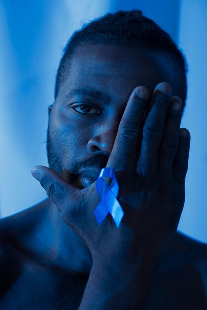 Portrait of african american man with blue ribbon