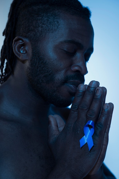 Portrait of african american man with blue ribbon