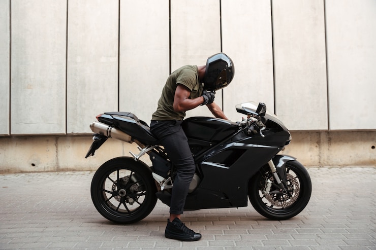 Free Photo portrait of an afro american man taking off a helmet