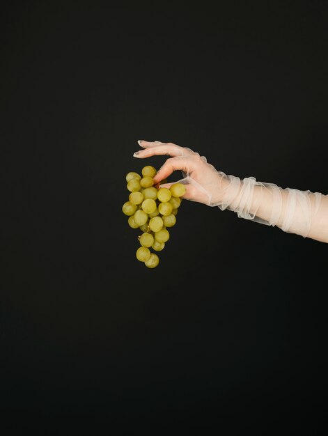 Portrait of albino woman holding grapes