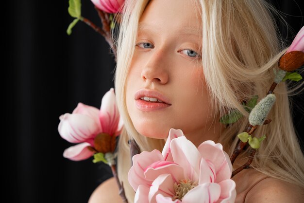 Portrait of albino woman with magnolia flowers