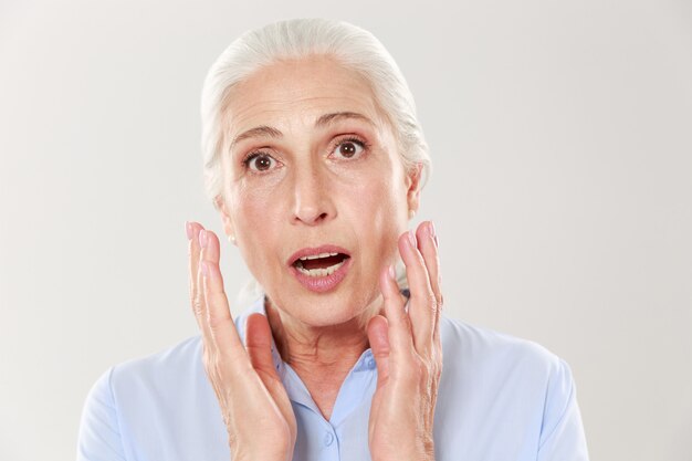 Portrait of amazed beautiful old woman