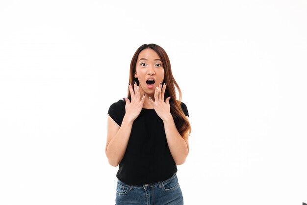 Portrait of  amazed young asian girl in black tshirt, looking at camera