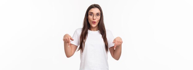 Portrait of amused and curious brunette female student inviting everyone check out very interesting