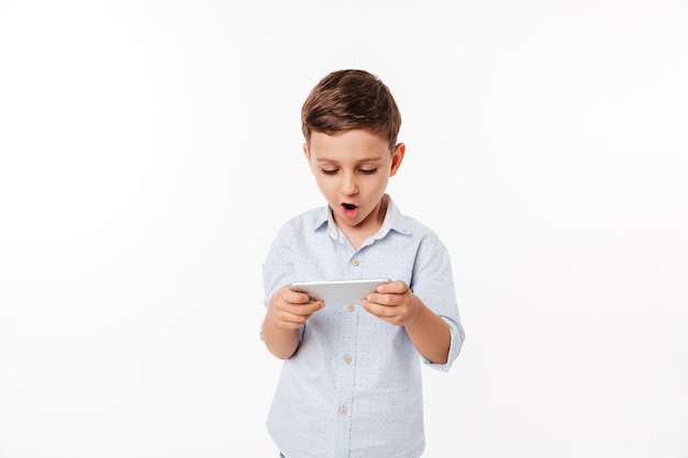 Portrait of an amused cute little kid playing games