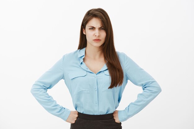 Portrait of angry brunette businesswoman posing in the studio